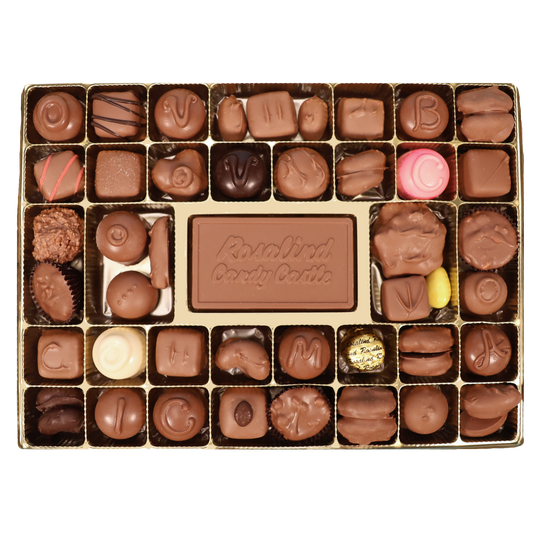 A top-down view of a 30-piece chocolate box from Rosalind Candy Castle featuring an assortment of milk and dark chocolates, pralines, and a pink and yellow candy, set against a plain white background.