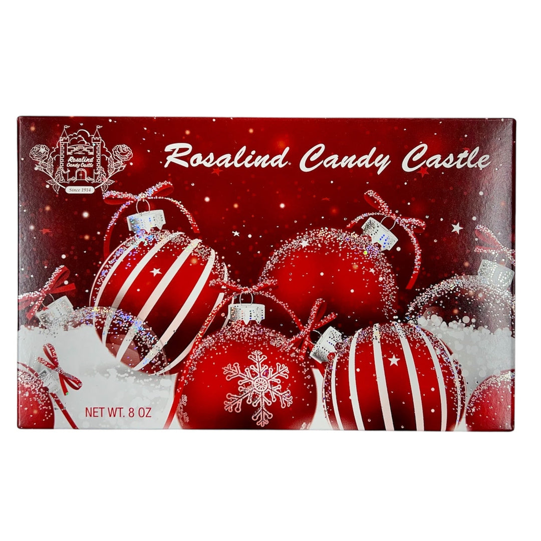 Rosalind Candy Castle chocolate box with Christmas ornaments on a red background
