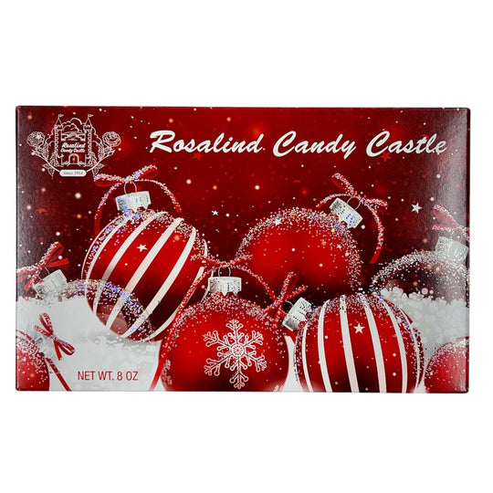Rosalind Candy Castle chocolate box with Christmas ornaments on a red background