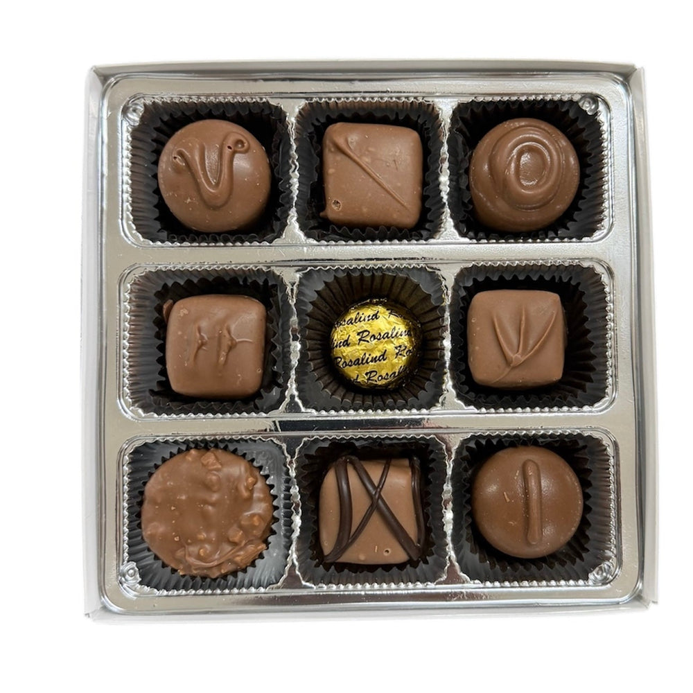 Assorted chocolates in a box on a white background