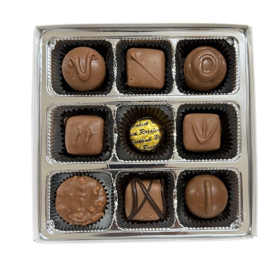 Assorted chocolates in a box on a white background